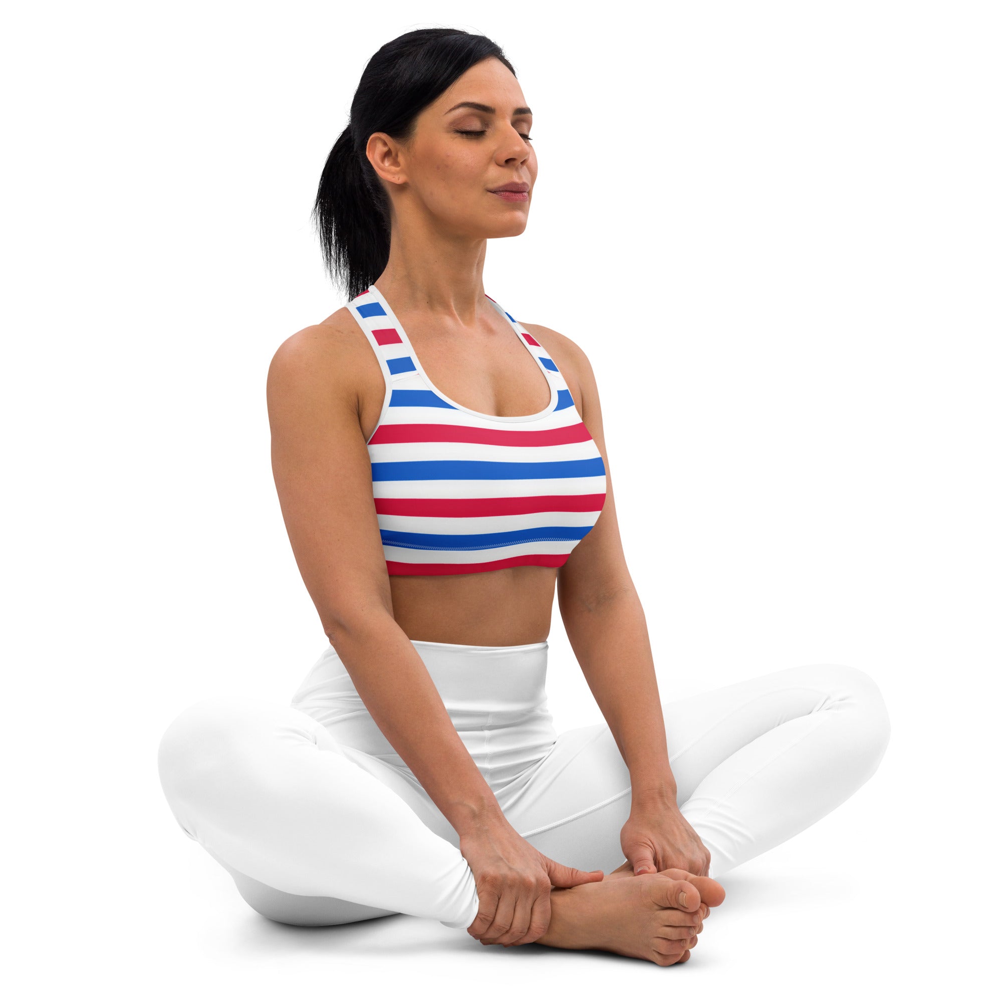A woman wearing a red white and blue quick drying sports bra with thin straps for active use