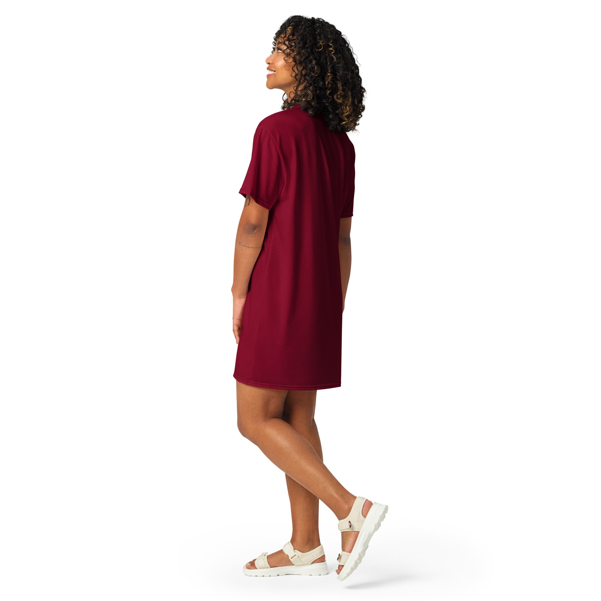 A woman wears a women’s burgundy t-shirt dress in maroon with short sleeves and a loose fitting simple design
