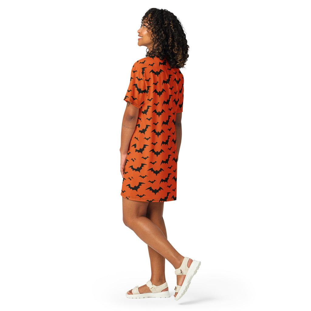 Women’s orange short-sleeved t-shirt dress with black bat pattern perfect for Halloween festivities