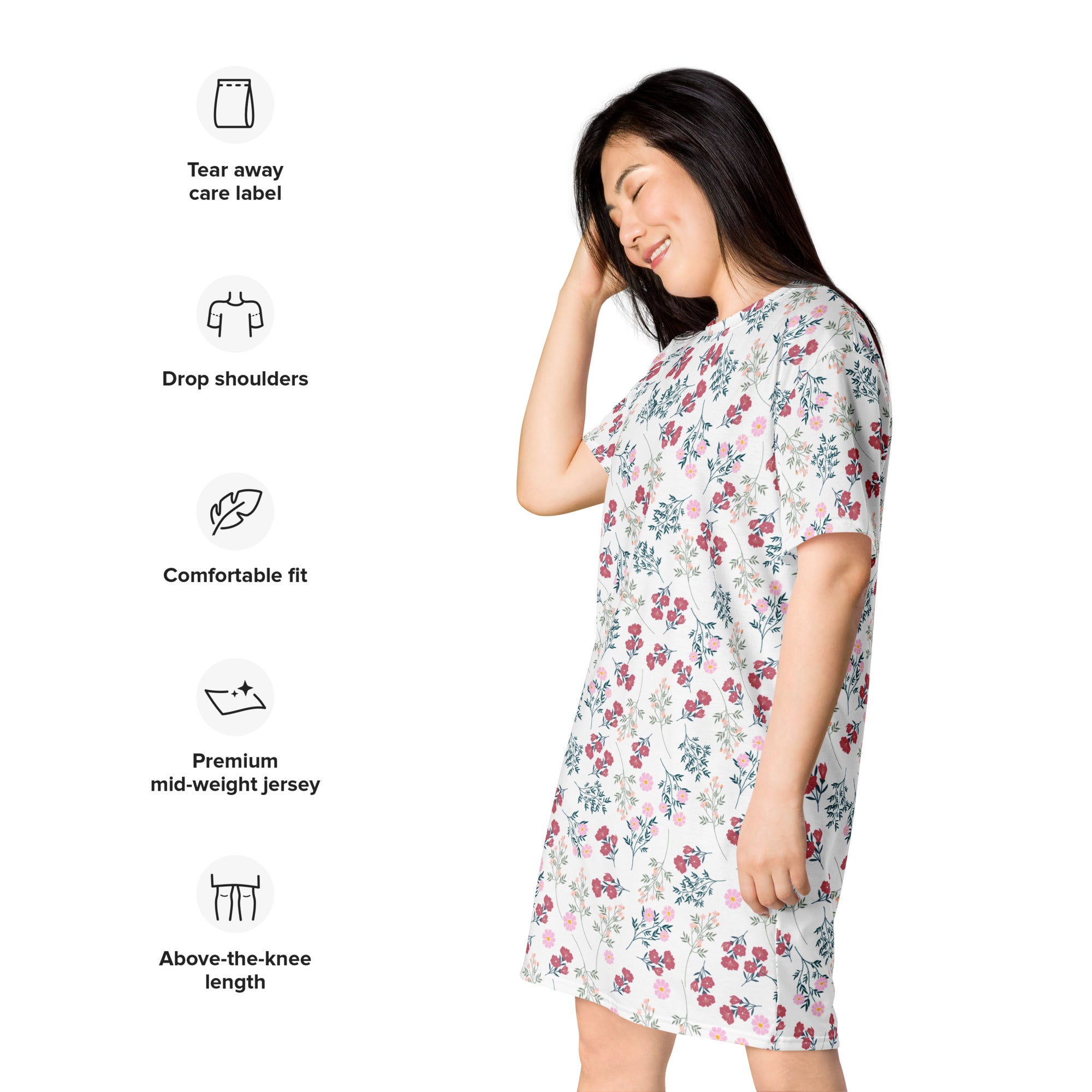 A woman wearing a women’s white floral t-shirt dress in premium mid-weight jersey with pink and green blossoms