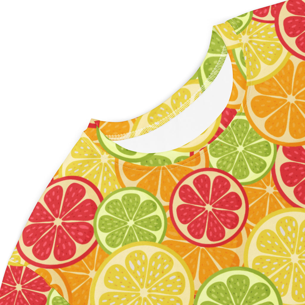 Women’s citrus fruit t-shirt dress with sleeveless vibrant citrus slice pattern in reds greens and yellows on light yellow background