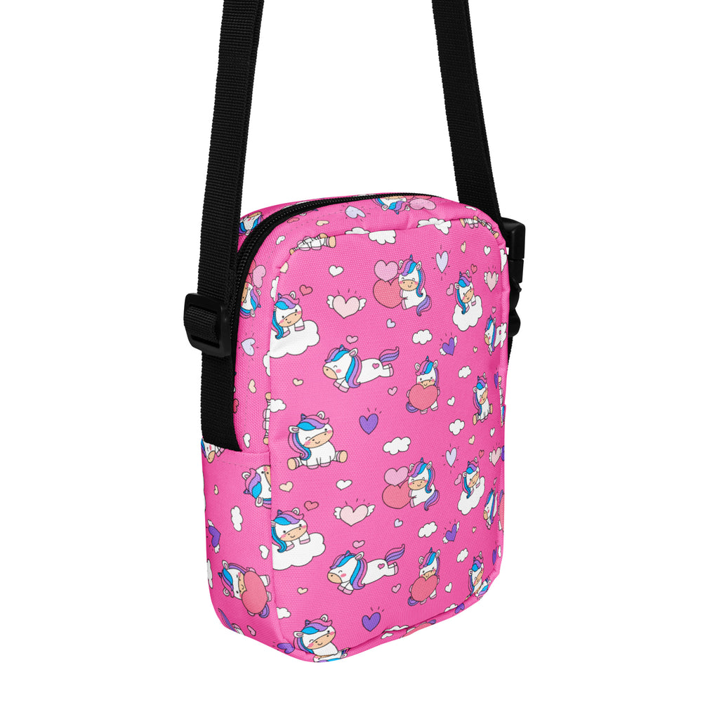 Girls pink unicorn crossbody purse featuring a pink unicorn pattern with a black adjustable strap