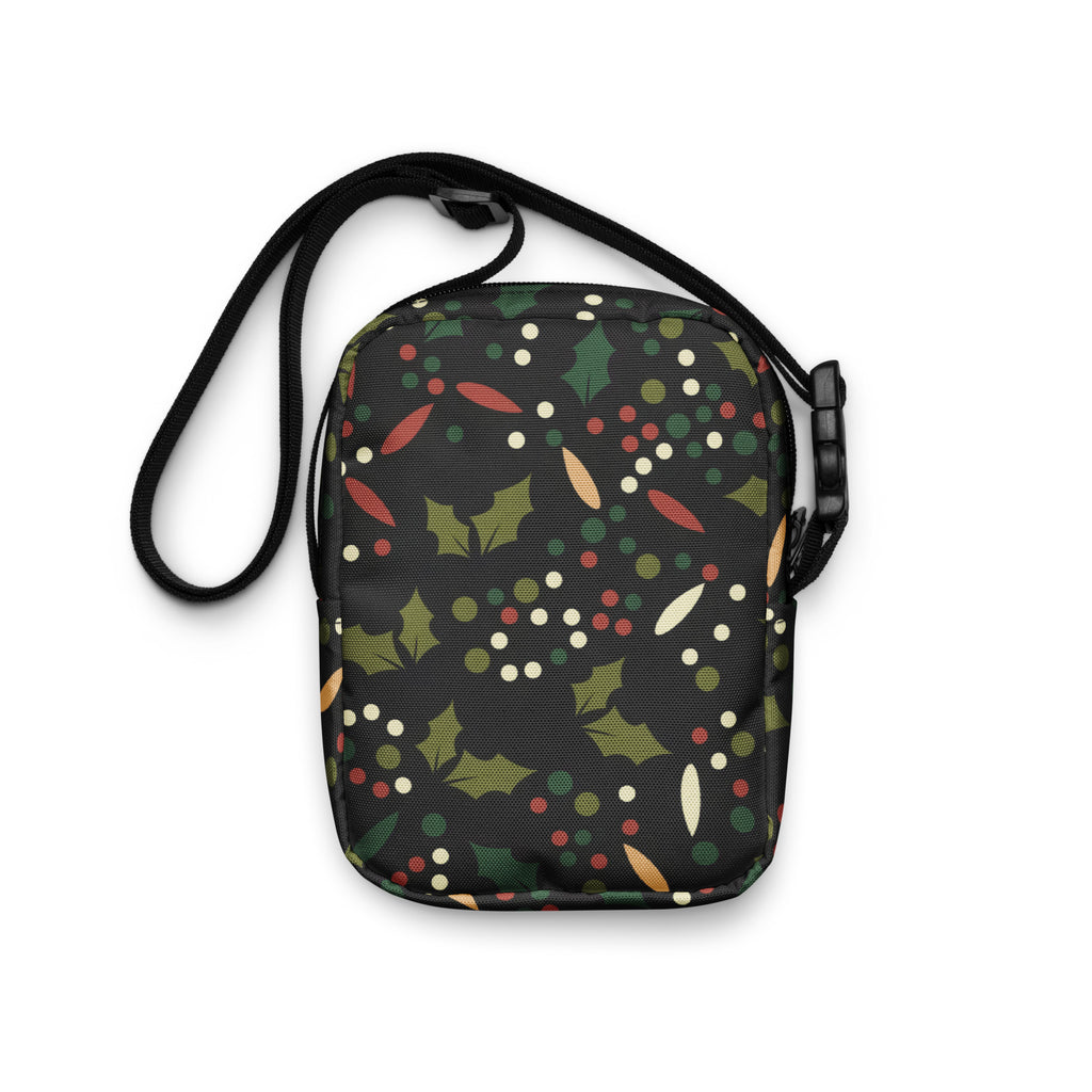 Black crossbody bag with red christmas holly and berries pattern featuring green leaves and colorful festive dots