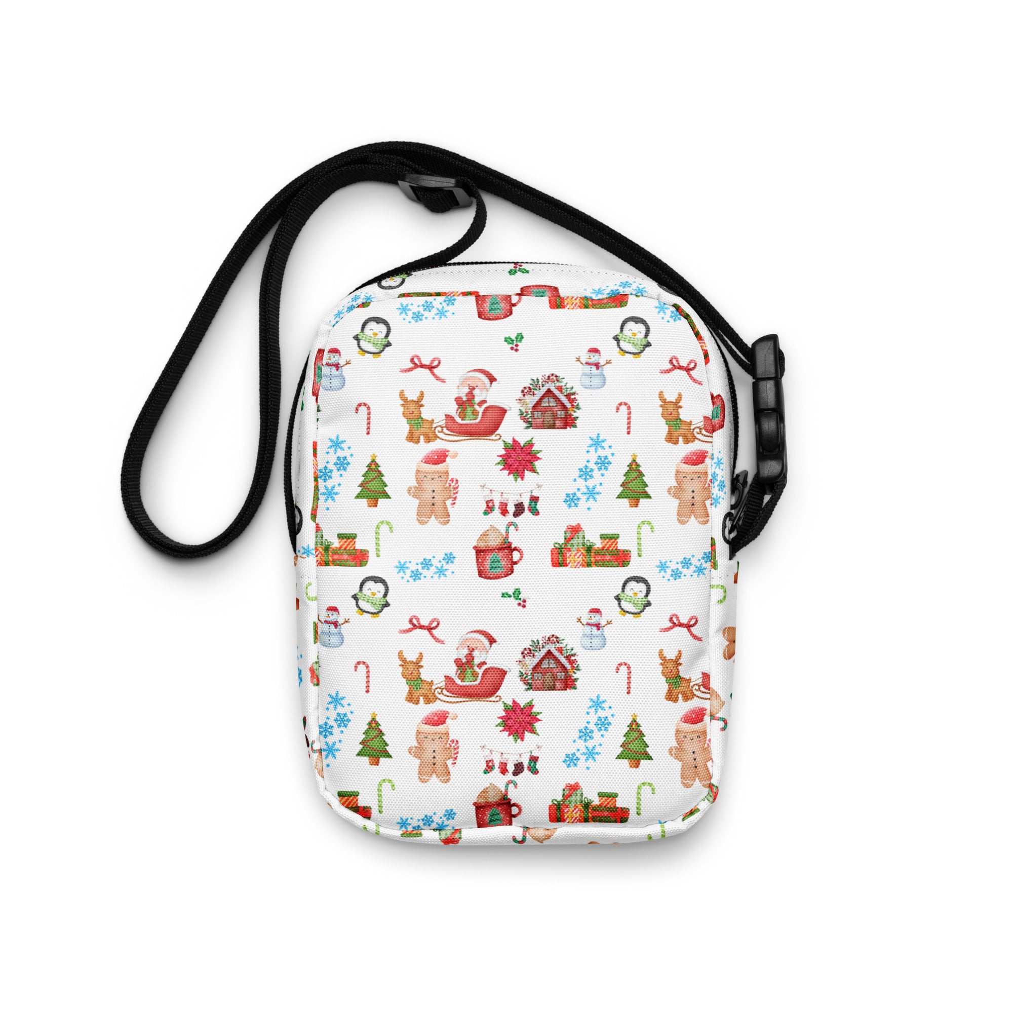 White crossbody bag with festive christmas pattern featuring gingerbread men snowmen reindeer on fabric surface
