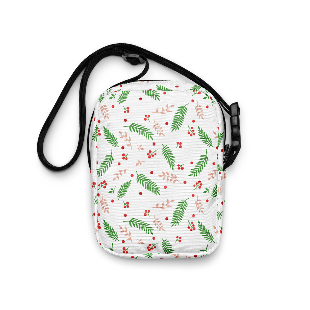 White winter fern and berry women’s crossbody purse with green and blush-pink leaf pattern and black adjustable strap