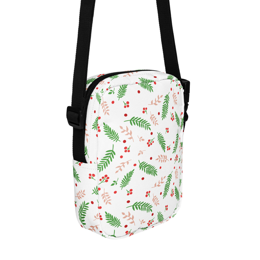 White winter fern and berry women’s crossbody purse with green and blush-pink fern pattern and black straps