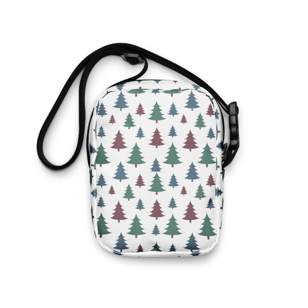 White crossbody bag with green and maroon pine tree pattern on textured fabric with black adjustable strap