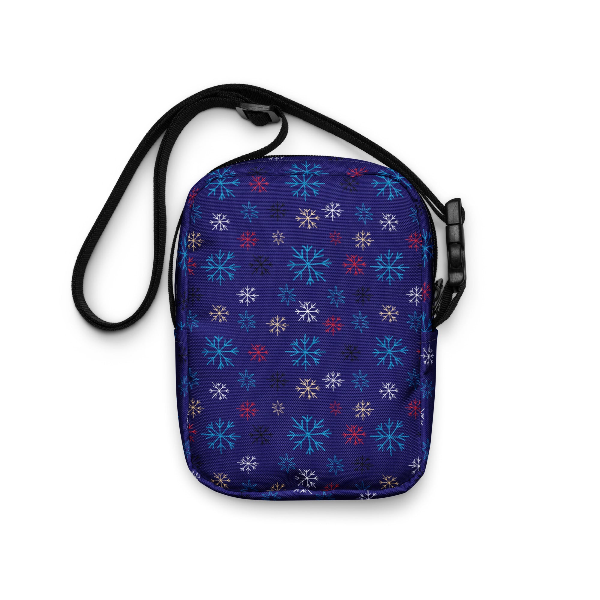 A navy blue crossbody purse with vibrant multicolored snowflake pattern for Christmas winter use