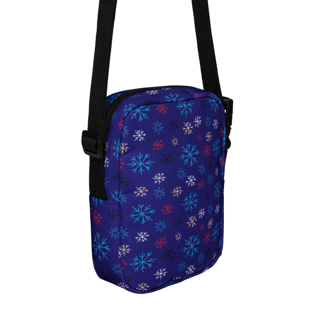 A navy blue crossbody purse with multicolored snowflake pattern for women’s Christmas winter use