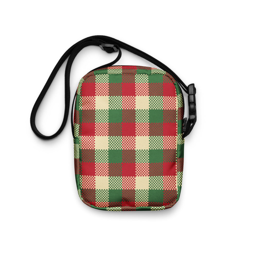 A festive red green and beige plaid winter women’s crossbody purse with a black adjustable strap