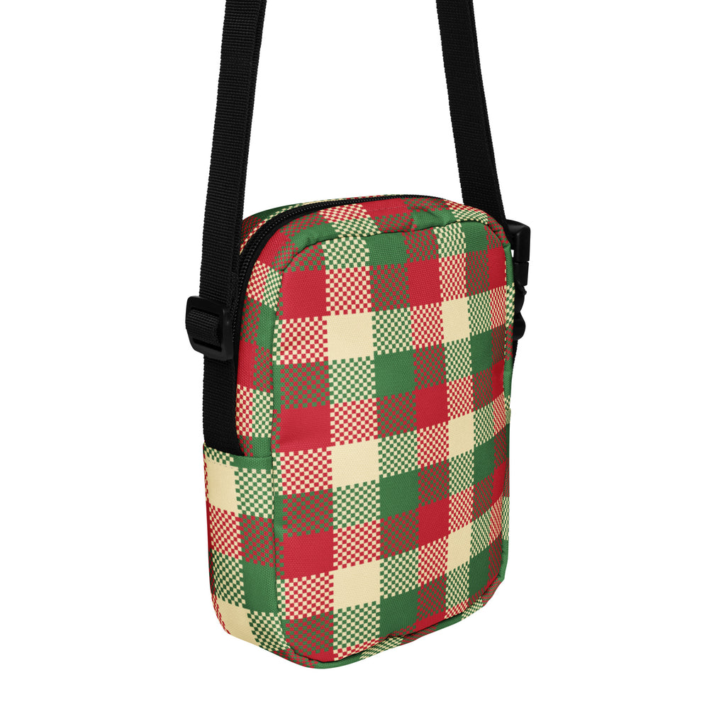 A festive christmas plaid winter women’s crossbody purse with red green beige checkered fabric and black adjustable straps