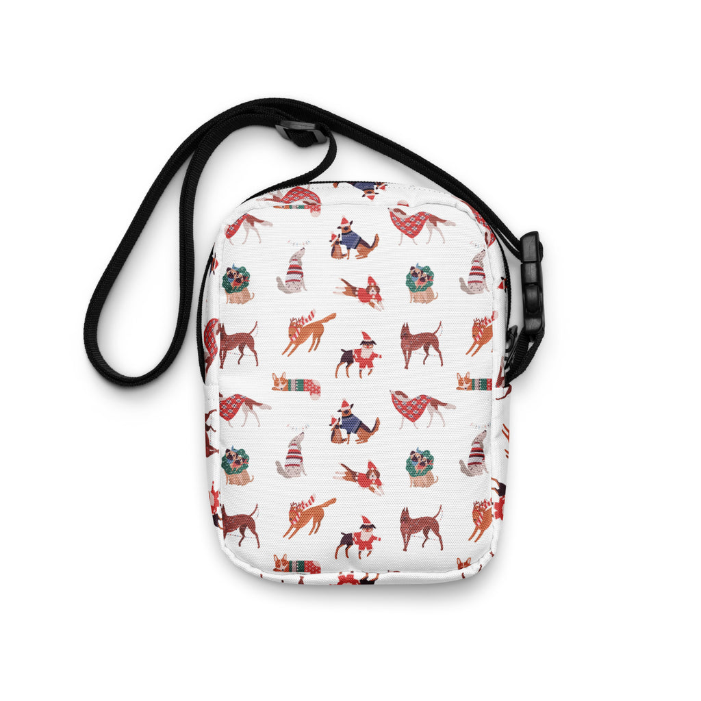 White crossbody bag with playful cartoon dogs in festive red and green holiday sweaters hats and scarves Christmas dogs purse