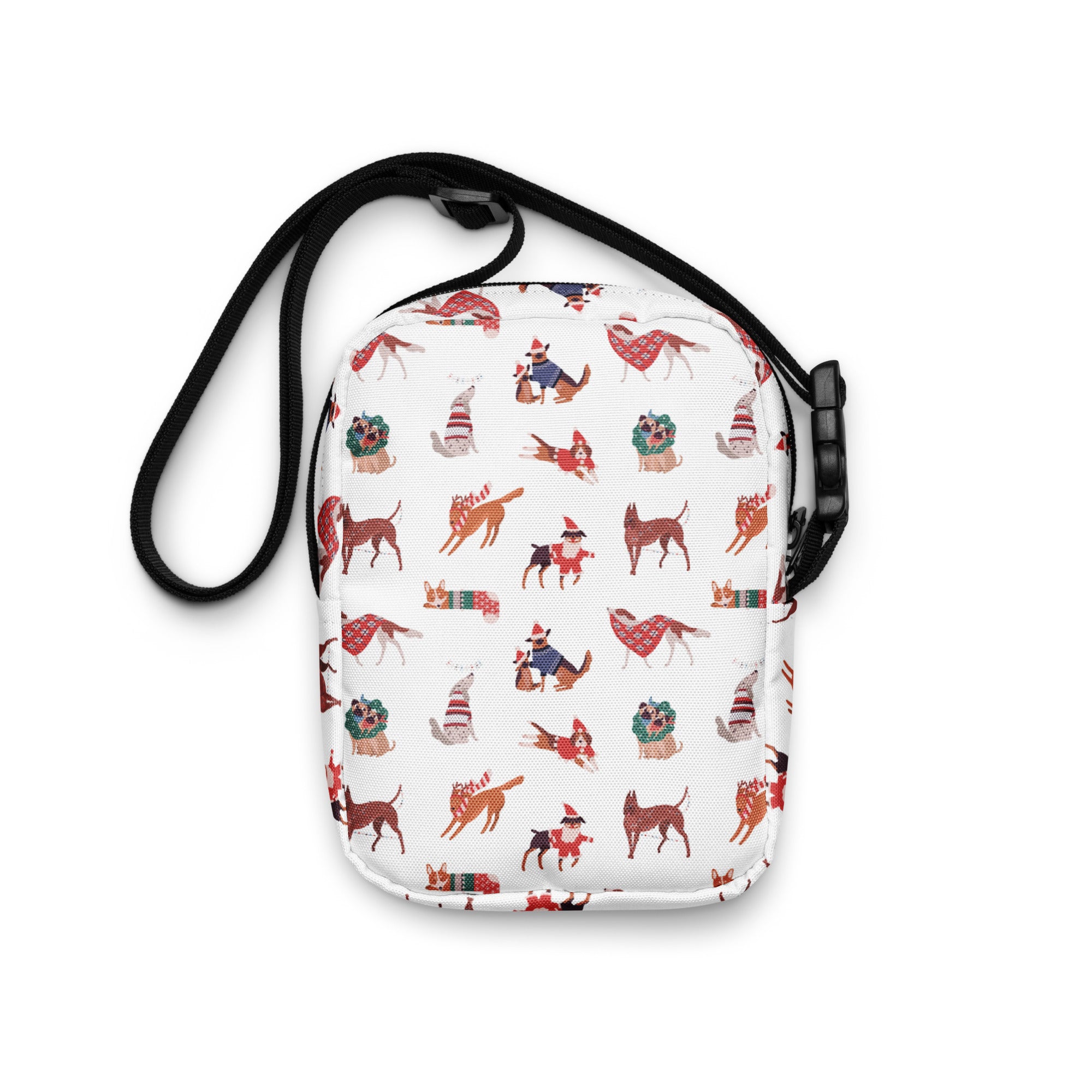 White crossbody bag with playful cartoon dogs in festive red and green holiday sweaters hats and scarves Christmas dogs purse