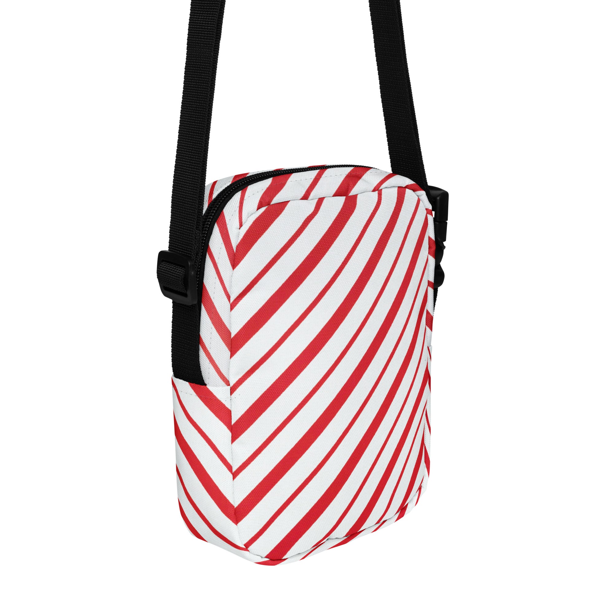 Girls candy cane stripe Christmas crossbody purse with red and white diagonal stripes and black adjustable straps