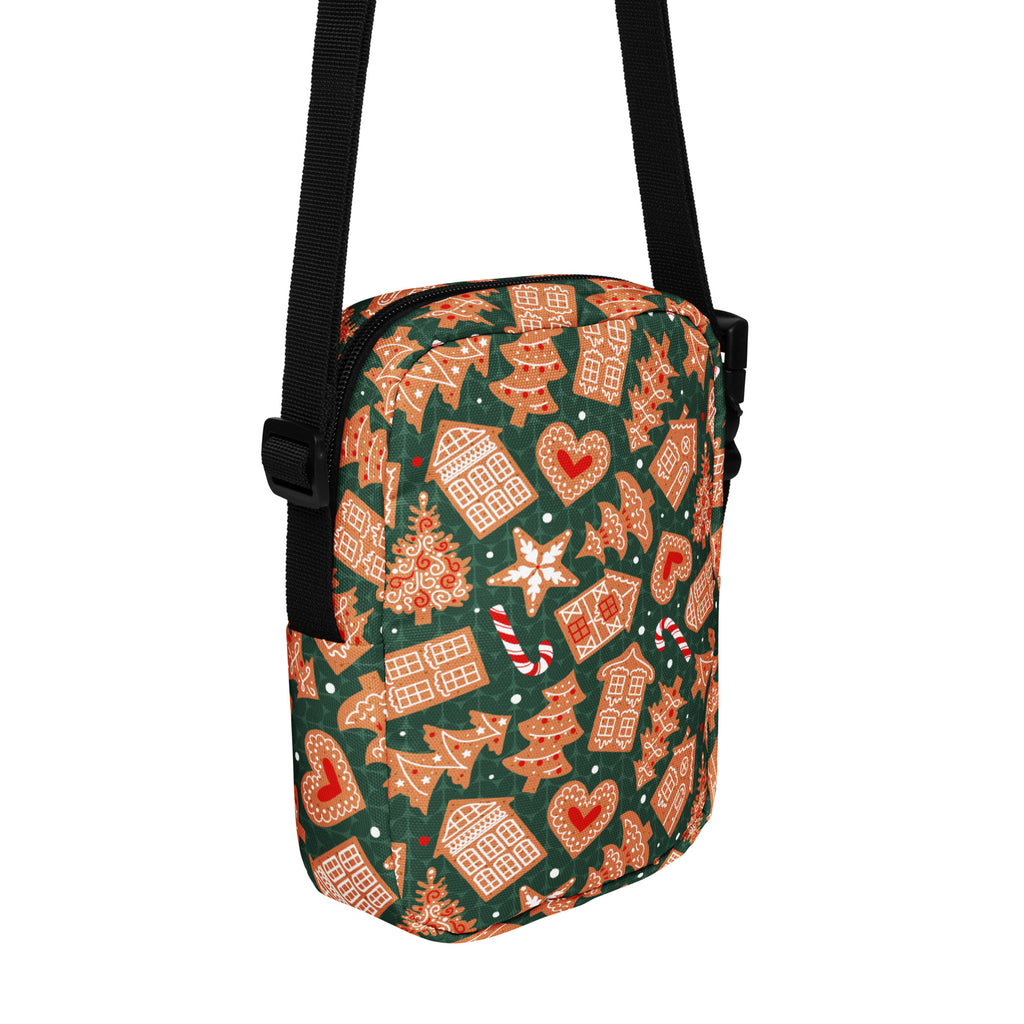 A festive green crossbody bag with gingerbread houses candy canes and hearts pattern for girls Christmas use