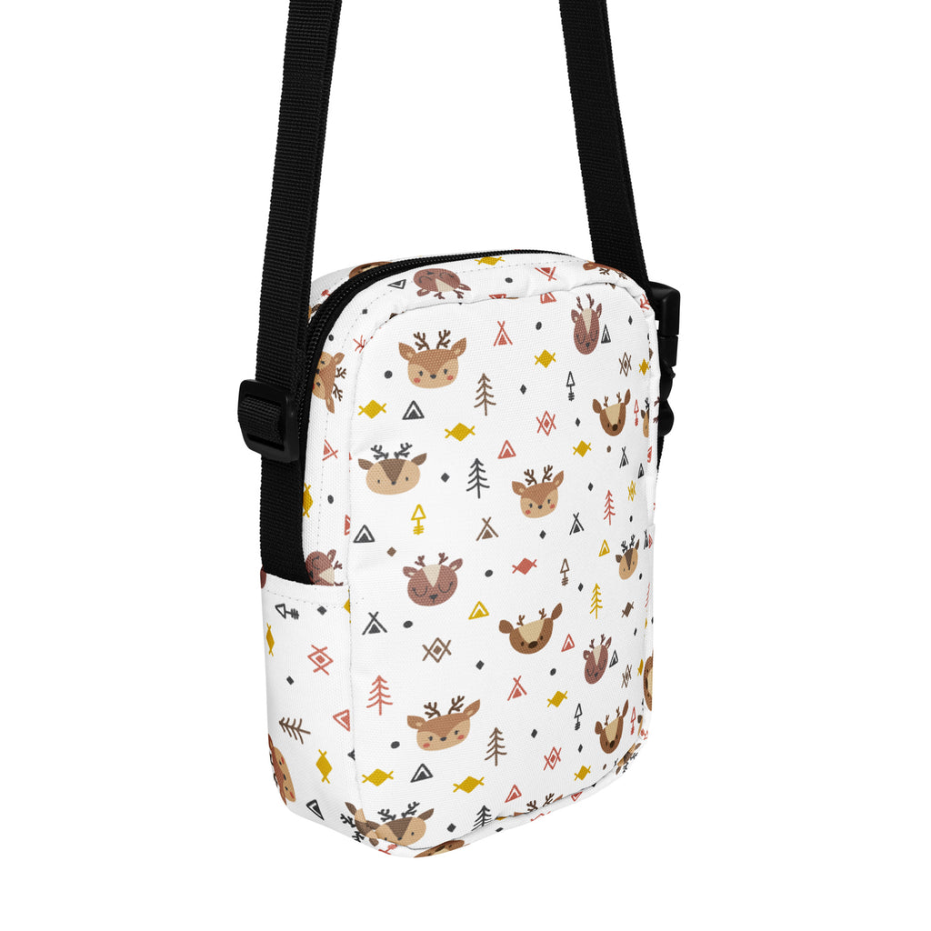 White crossbody bag for girls featuring a playful reindeer pattern with trees and geometric shapes in brown and bright colors