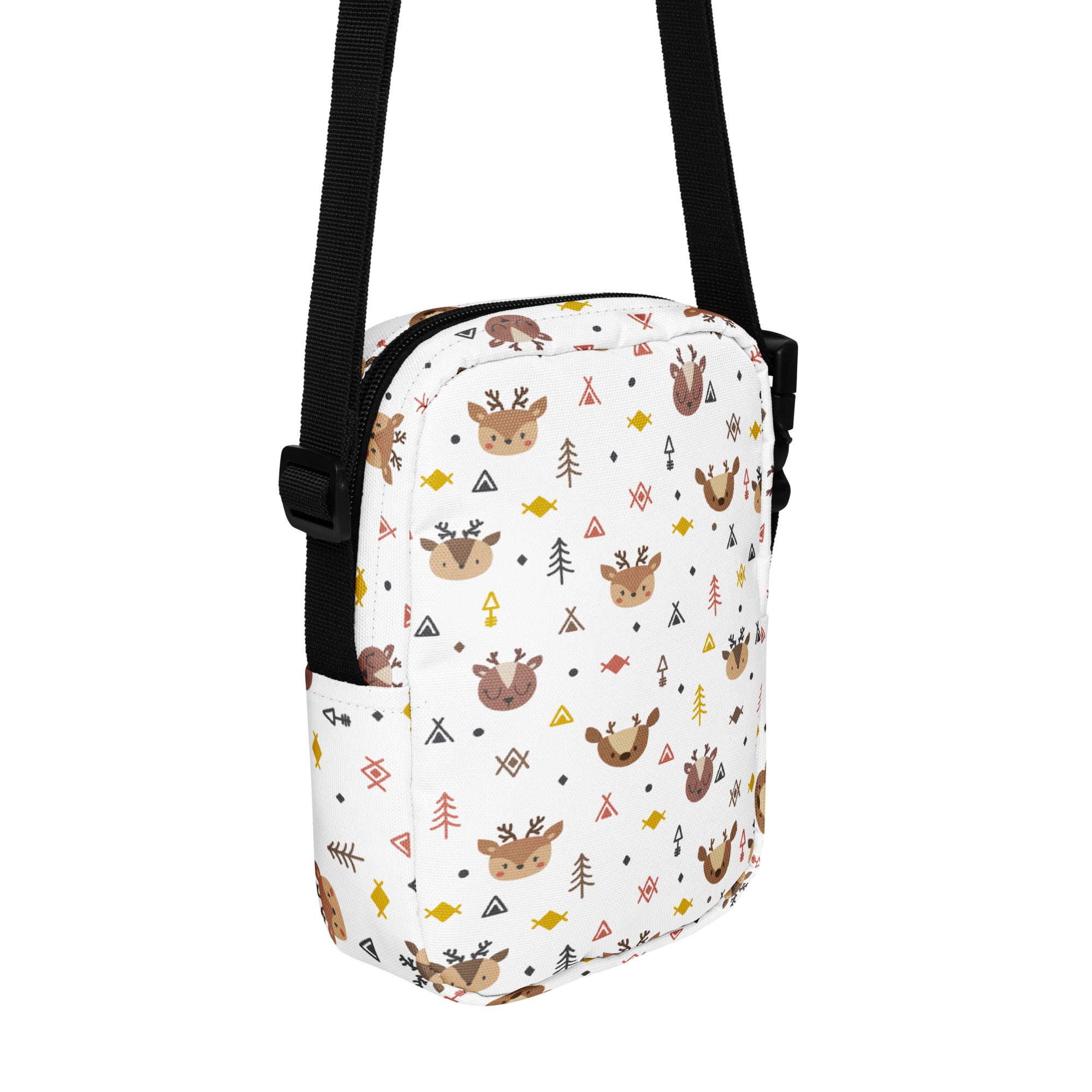 White crossbody bag for girls featuring a playful reindeer pattern with trees and geometric shapes in brown and bright colors