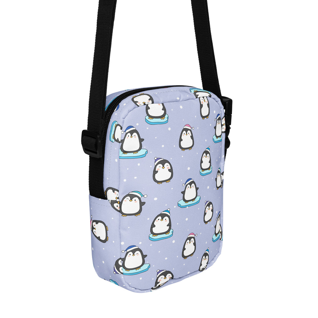 A light purple cute winter penguins women’s crossbody purse with playful cartoon penguins and snowflake accents