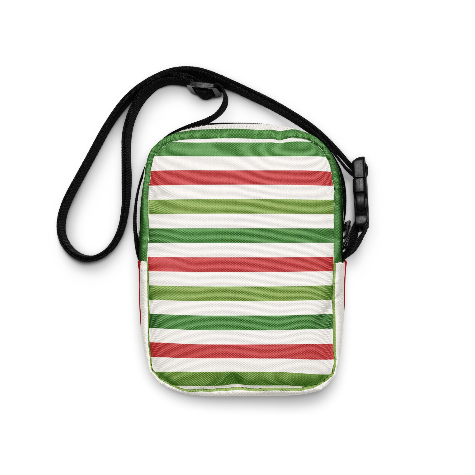 A Christmas striped women’s crossbody purse with bold green red and white fabric stripes and black adjustable strap hardware