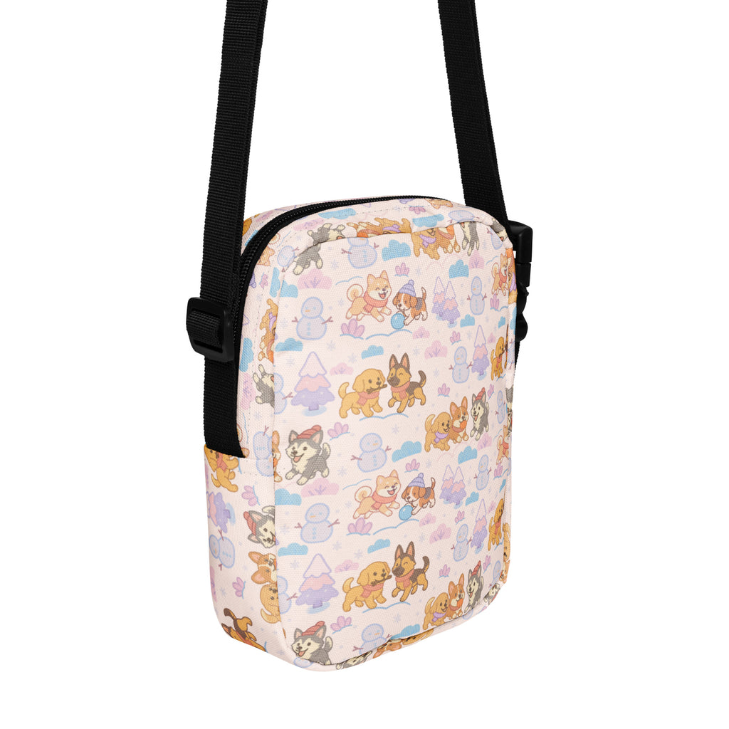 Girls winter dog crossbody purse in pink with playful pastel cartoon dogs snowmen and trees pattern