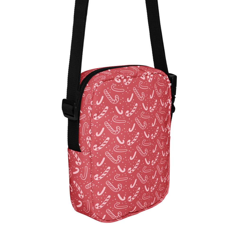 Girls red candy cane patterned crossbody purse with black straps for festive holiday style and easy carrying