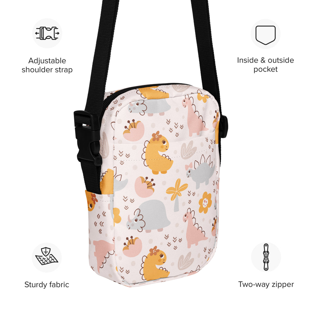 Girls floral dinosaur crossbody purse in white with playful yellow pink and gray cartoon dinosaur pattern on fabric