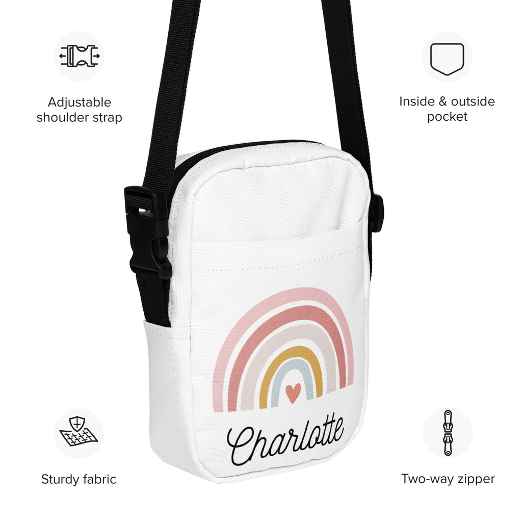 White crossbody bag with pastel rainbow heart design personalized with the name charlotte in black cursive