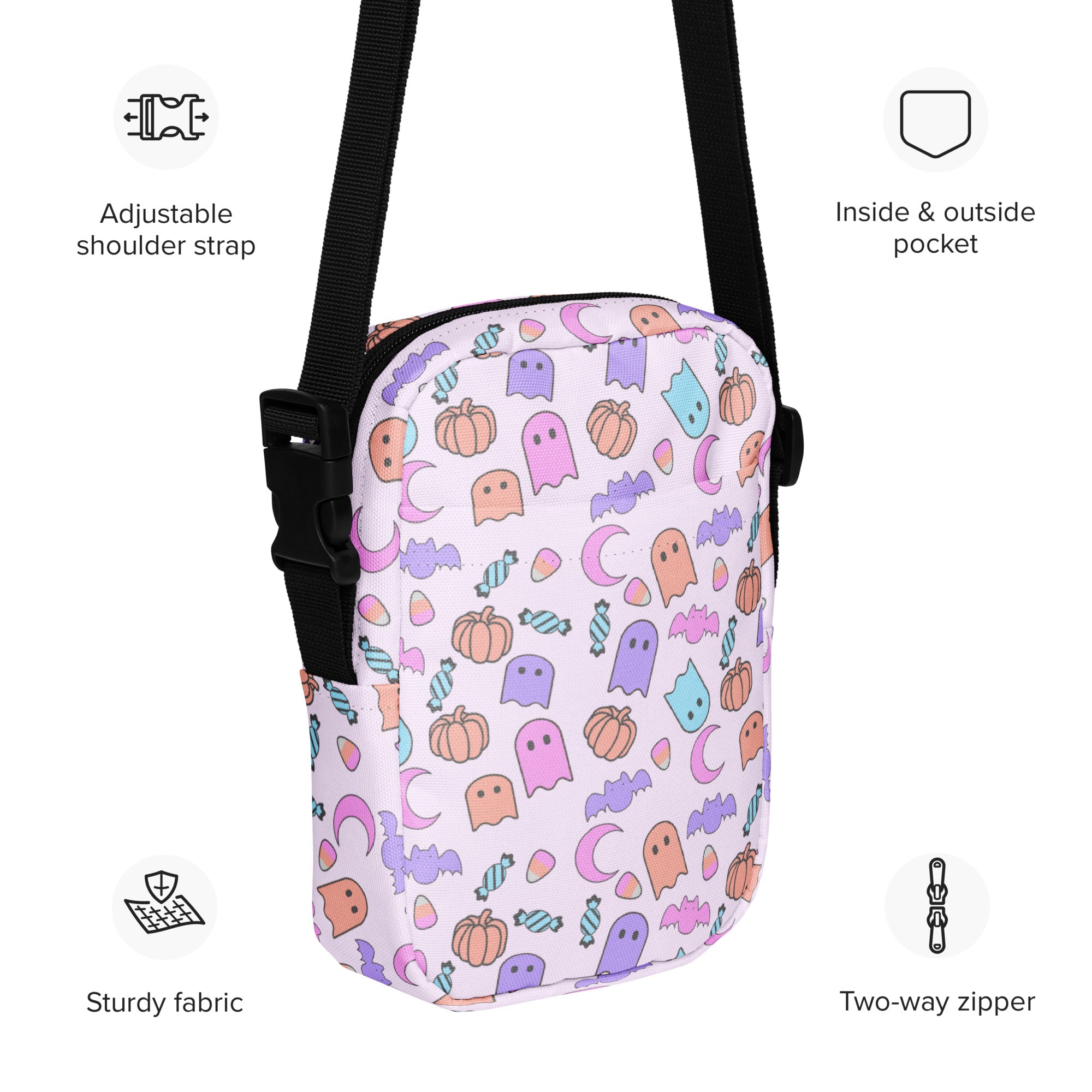 A white girls ghost halloween crossbody purse with pastel ghosts pumpkins bats and candy in pink purple orange and blue