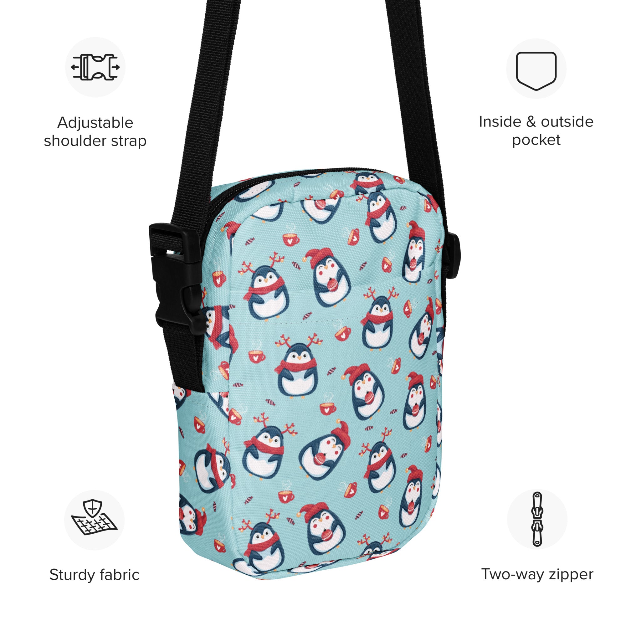 Light blue girls reindeer penguin crossbody purse with playful cartoon penguin pattern and black adjustable straps