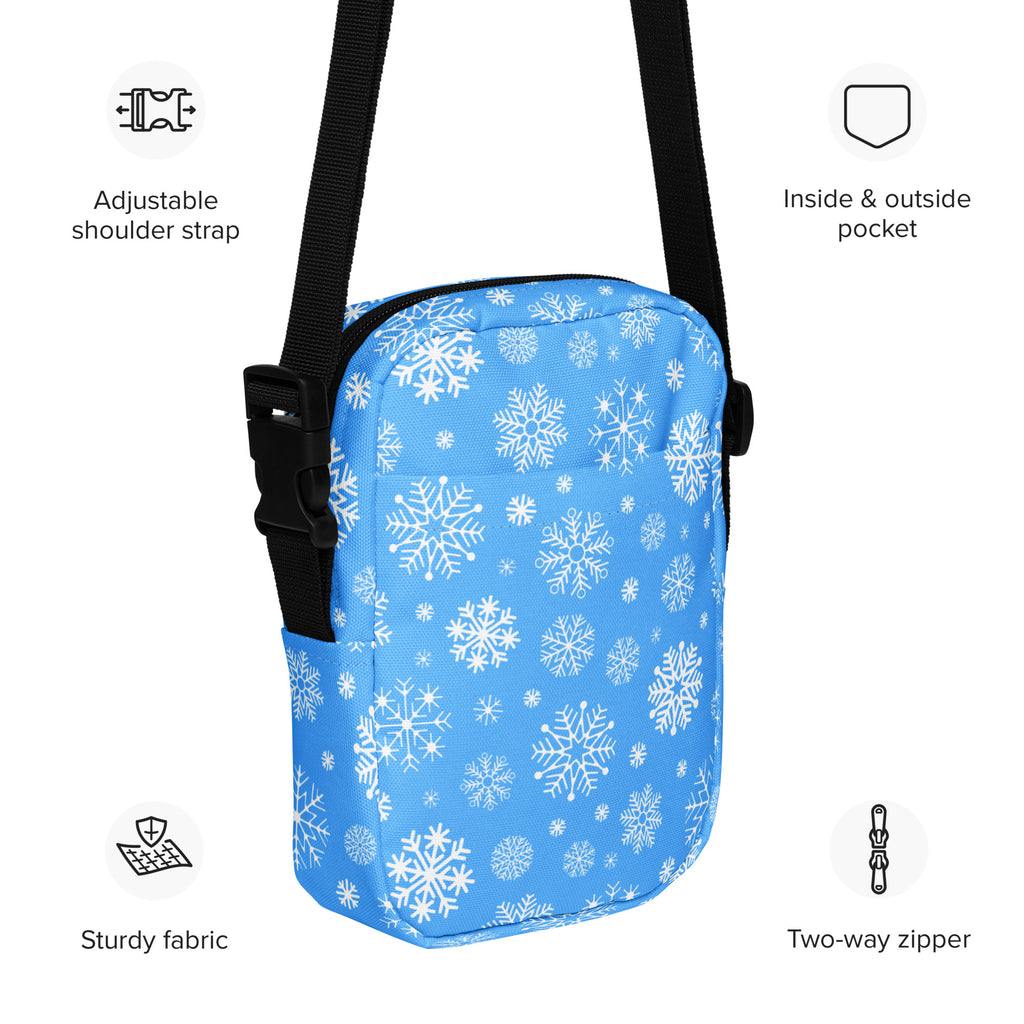 Blue snowflake winter women’s crossbody purse with white snowflake pattern and black adjustable strap