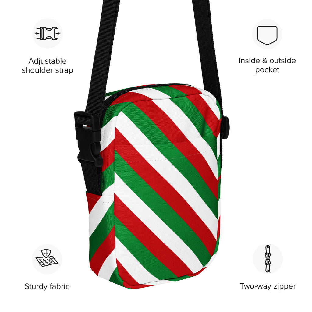 A festive red green and white diagonally striped crossbody purse with a black adjustable strap for women