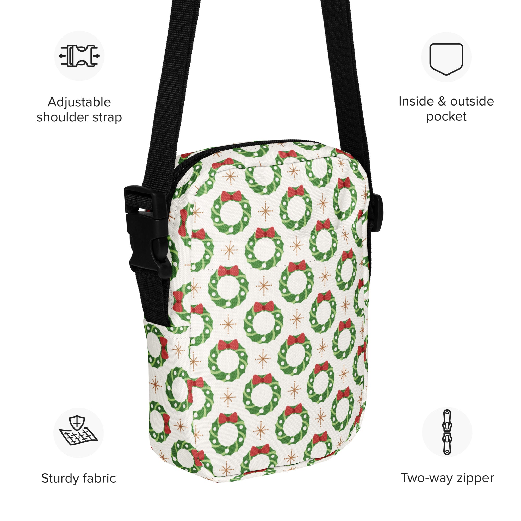 White crossbody purse with festive green wreath pattern red bows and gold stars made from sturdy fabric for Christmas use