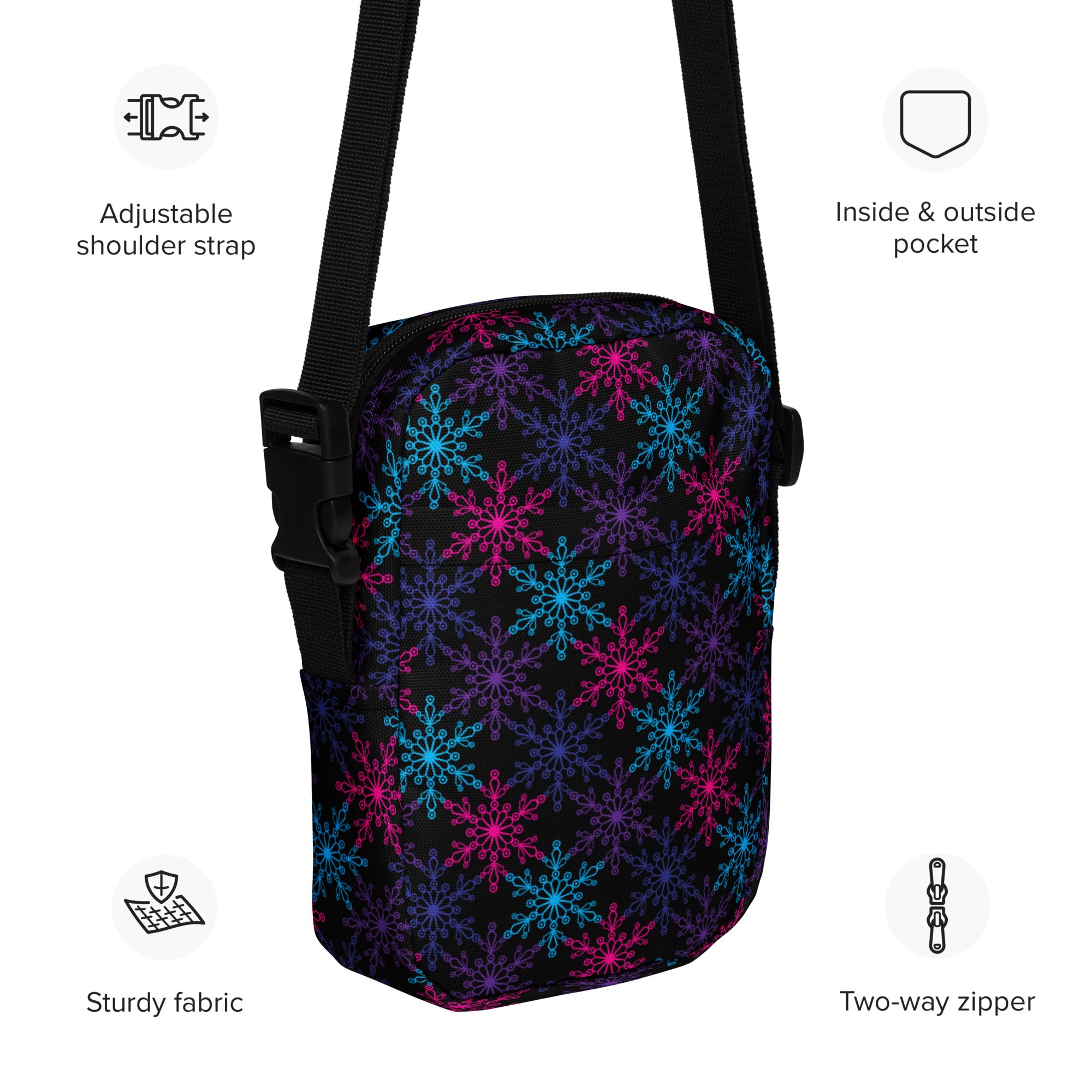 A black girls neon snowflakes crossbody purse with vibrant pink blue and purple snowflake pattern