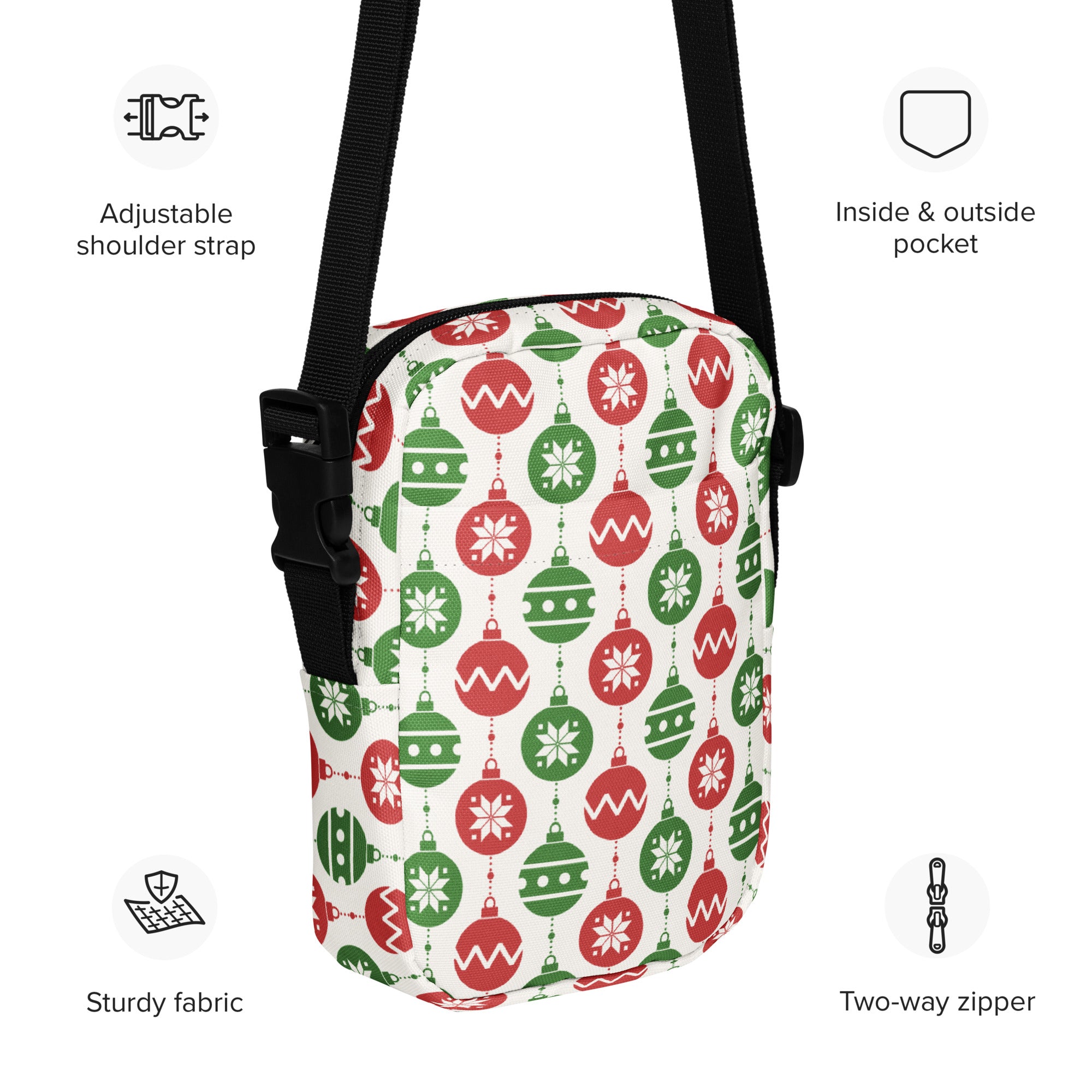 A festive white crossbody purse with red and green christmas ornament patterns made from sturdy fabric
