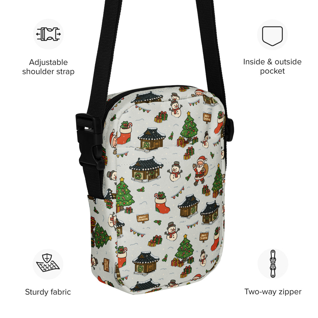 White crossbody bag with festive christmas print of snowmen santa claus and traditional korean houses on light background