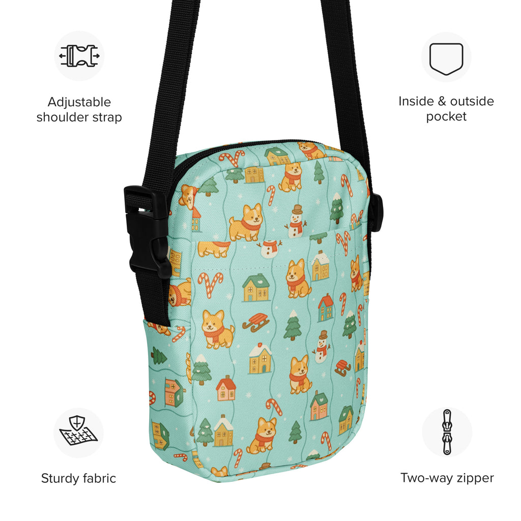 A light blue fabric shiba inu christmas crossbody purse with cartoon corgis snowmen houses and candy cane pattern