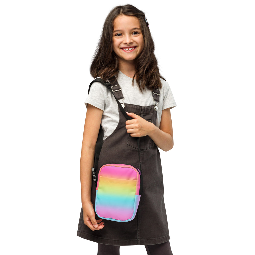 Girls bright rainbow crossbody purse made of soft fabric with adjustable black straps for comfortable wear