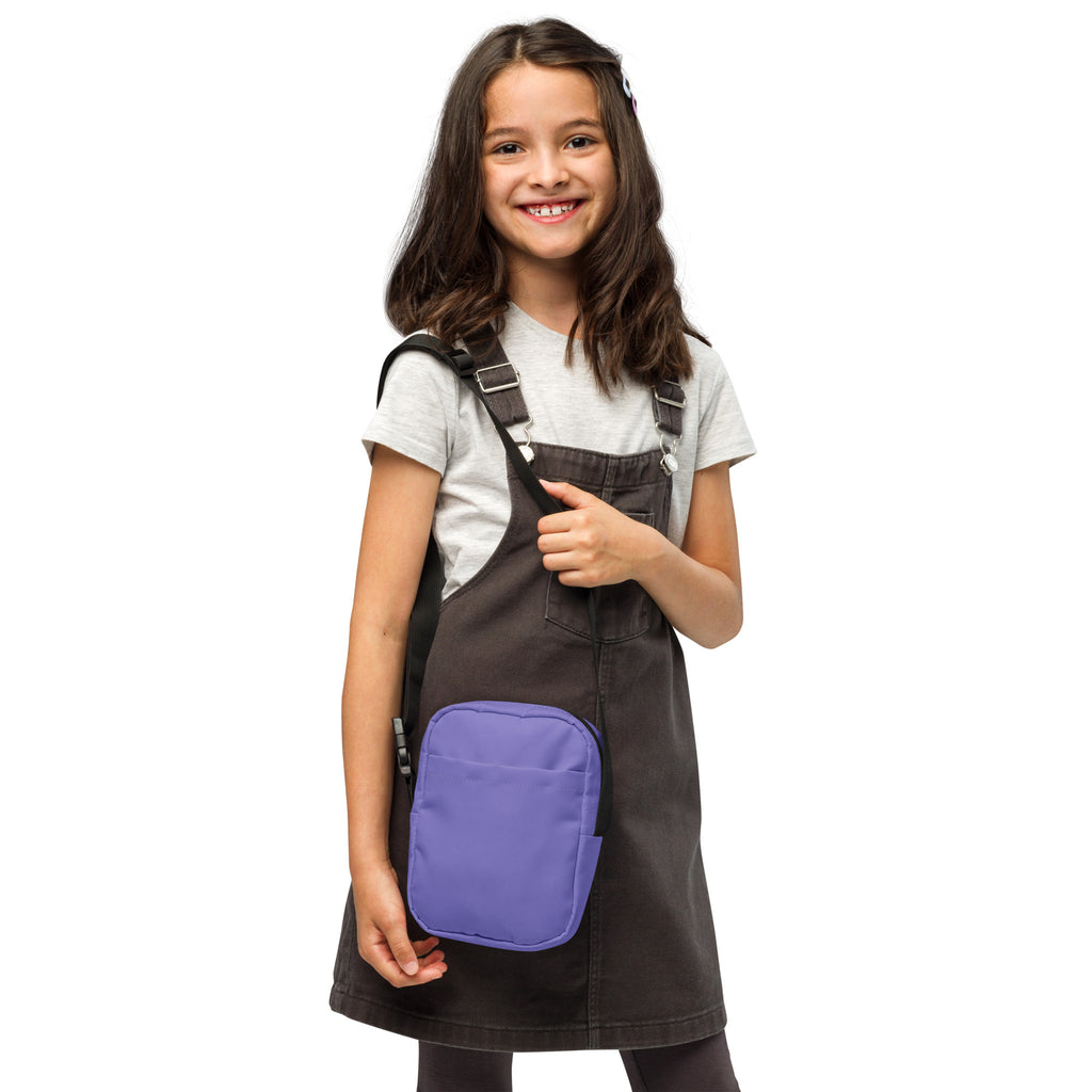 Dark gray denim overalls with a purple rectangular front pocket and girls purple crossbody purse detail