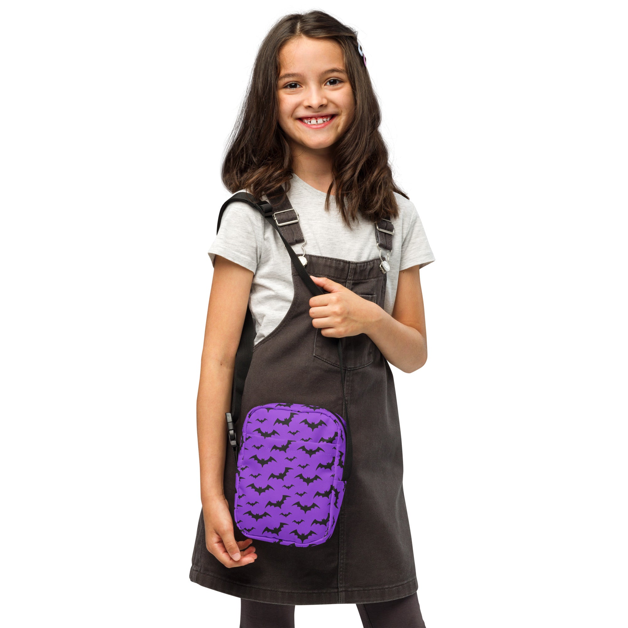 Kids purple bats halloween crossbody purse featuring a bat-patterned pouch with black straps worn crossbody