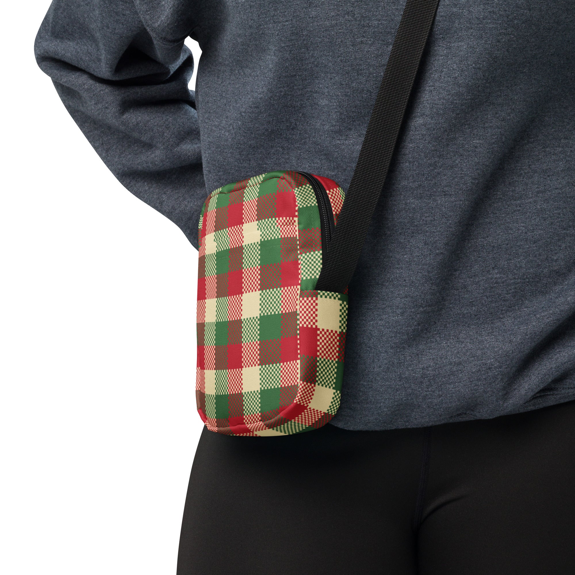 A compact crossbody bag with festive red green and beige plaid and subtle textured accents for winter use