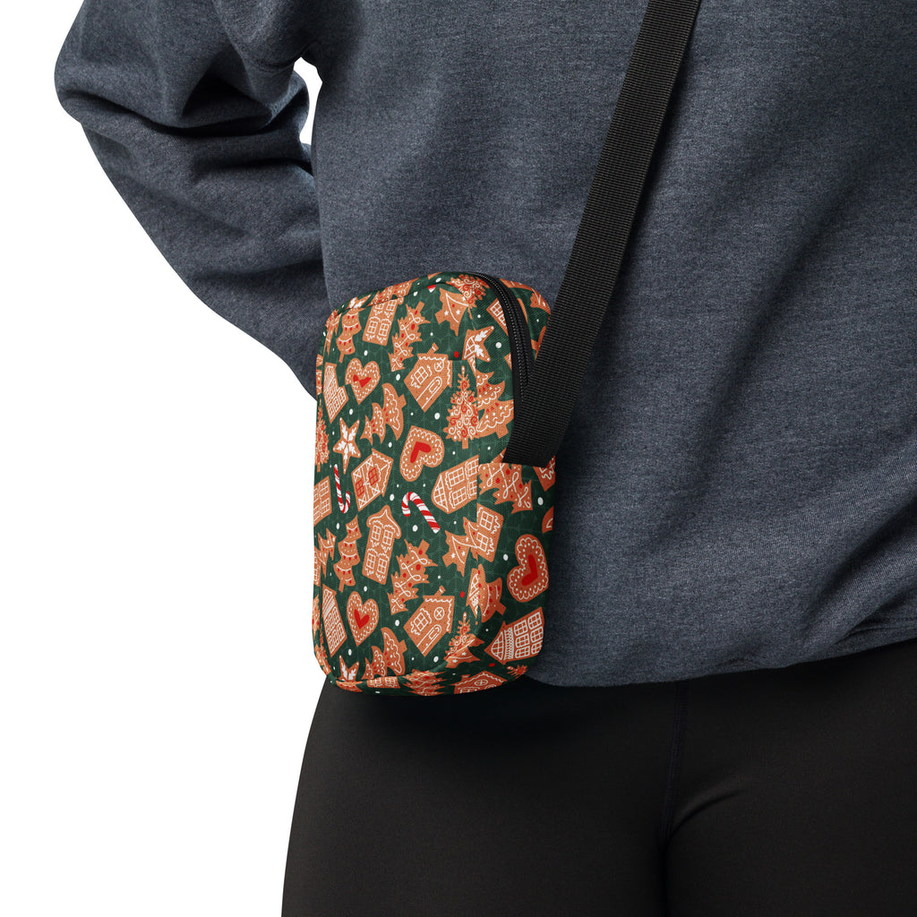 Green gingerbread Christmas women’s crossbody purse in festive green and orange with a black strap and gingerbread design