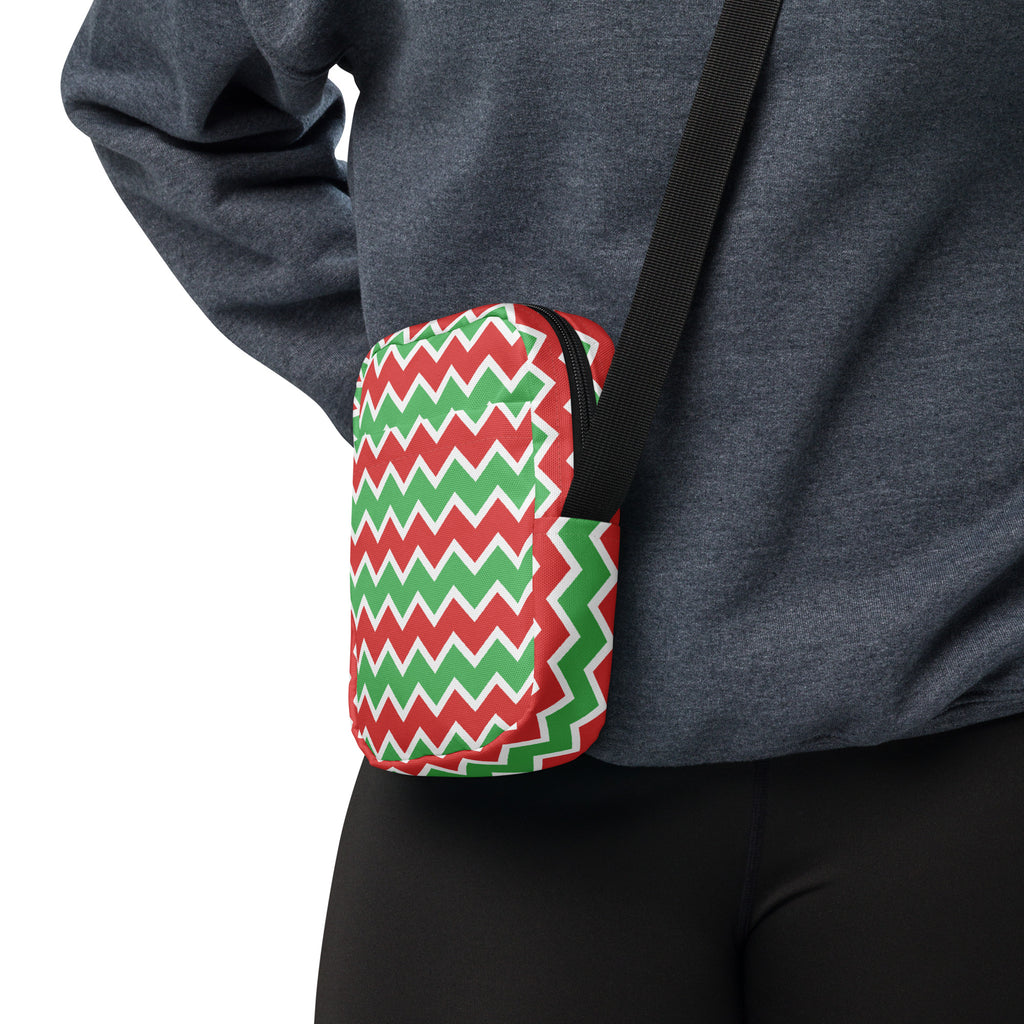 A compact crossbody purse with vibrant red green and white zigzag pattern perfect for Christmas use