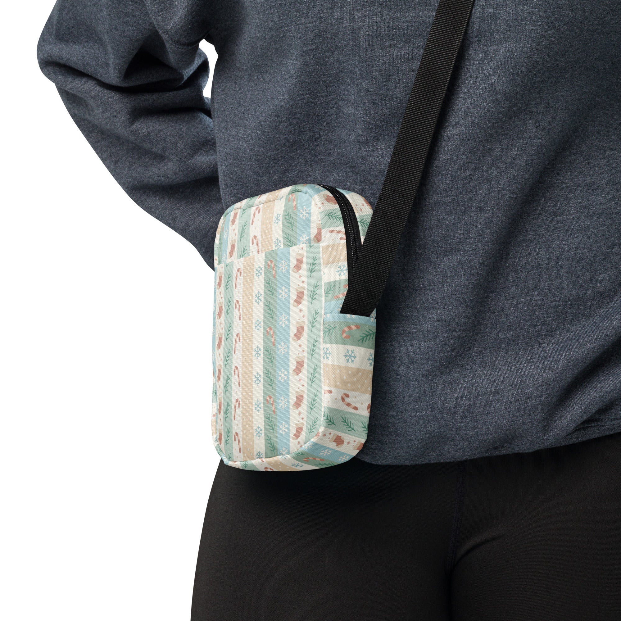 A cozy rectangular crossbody bag in pastel stripes with holiday motifs on soft fabric for festive use