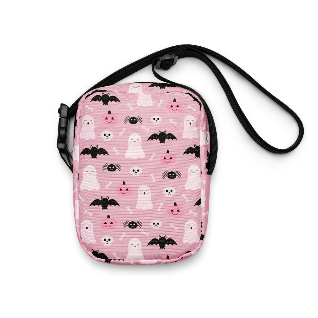 Girls cute ghost and bats pink halloween crossbody purse with playful pattern on soft pink fabric