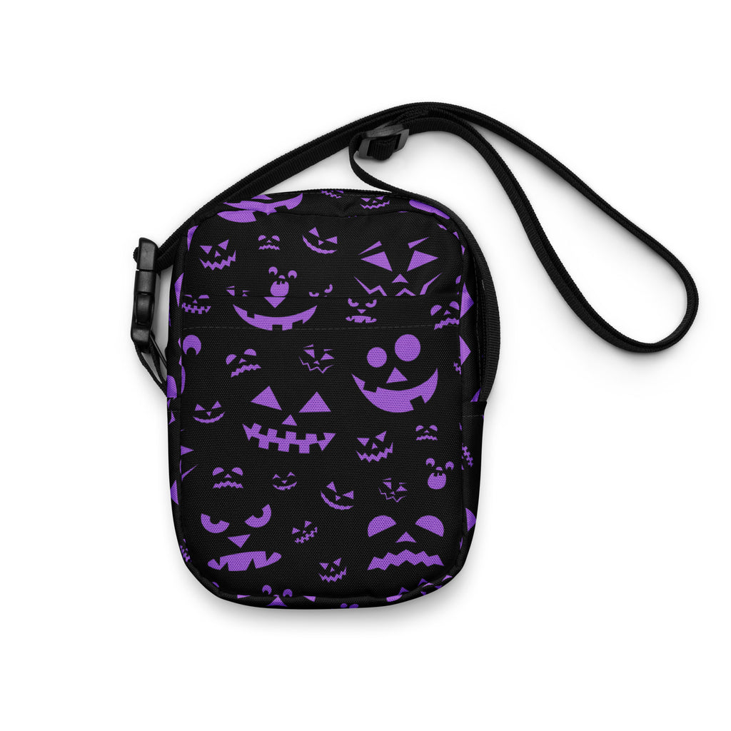 Black crossbody bag with vibrant purple jack-o-lantern faces designed for girls halloween use