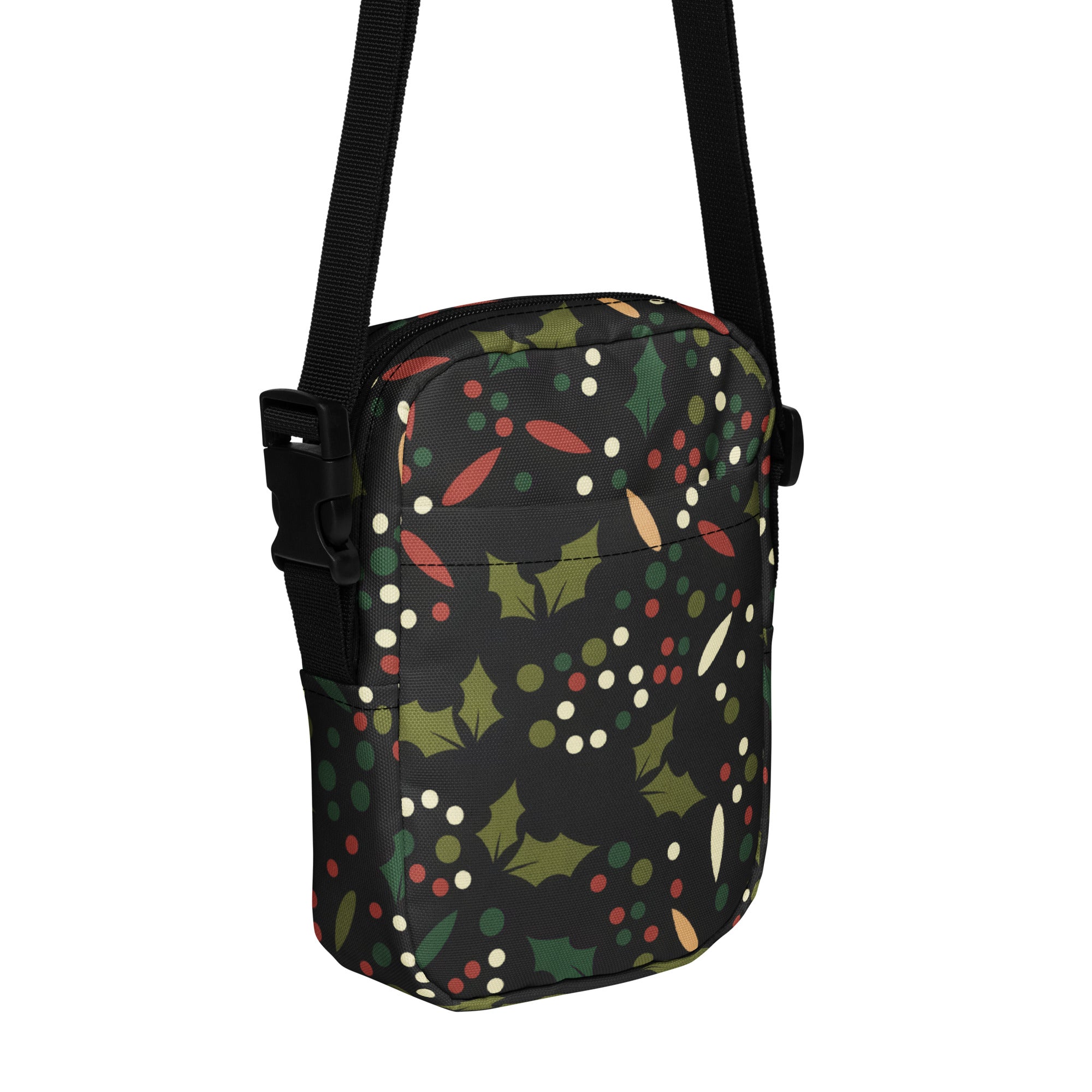 Black girls crossbody bag with festive green holly leaves red and white berries pattern for Christmas use