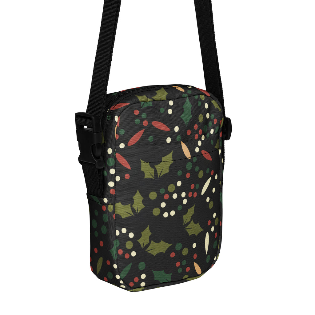 Black crossbody bag with red christmas holly and berries festive pattern of green leaves and multicolor dots