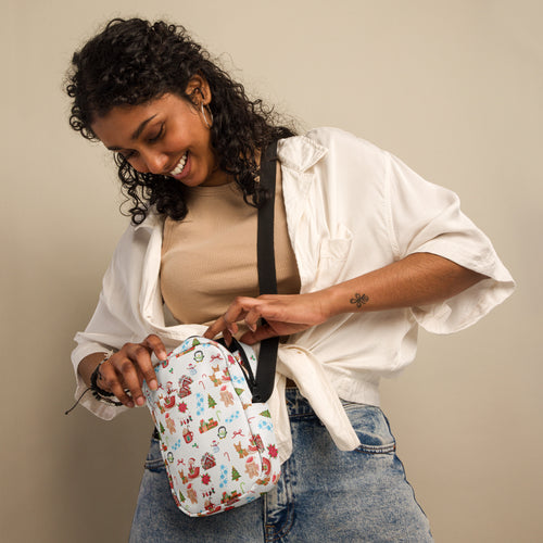 White crossbody bag with festive candy cane snowmen and christmas tree print in red green and blue for women