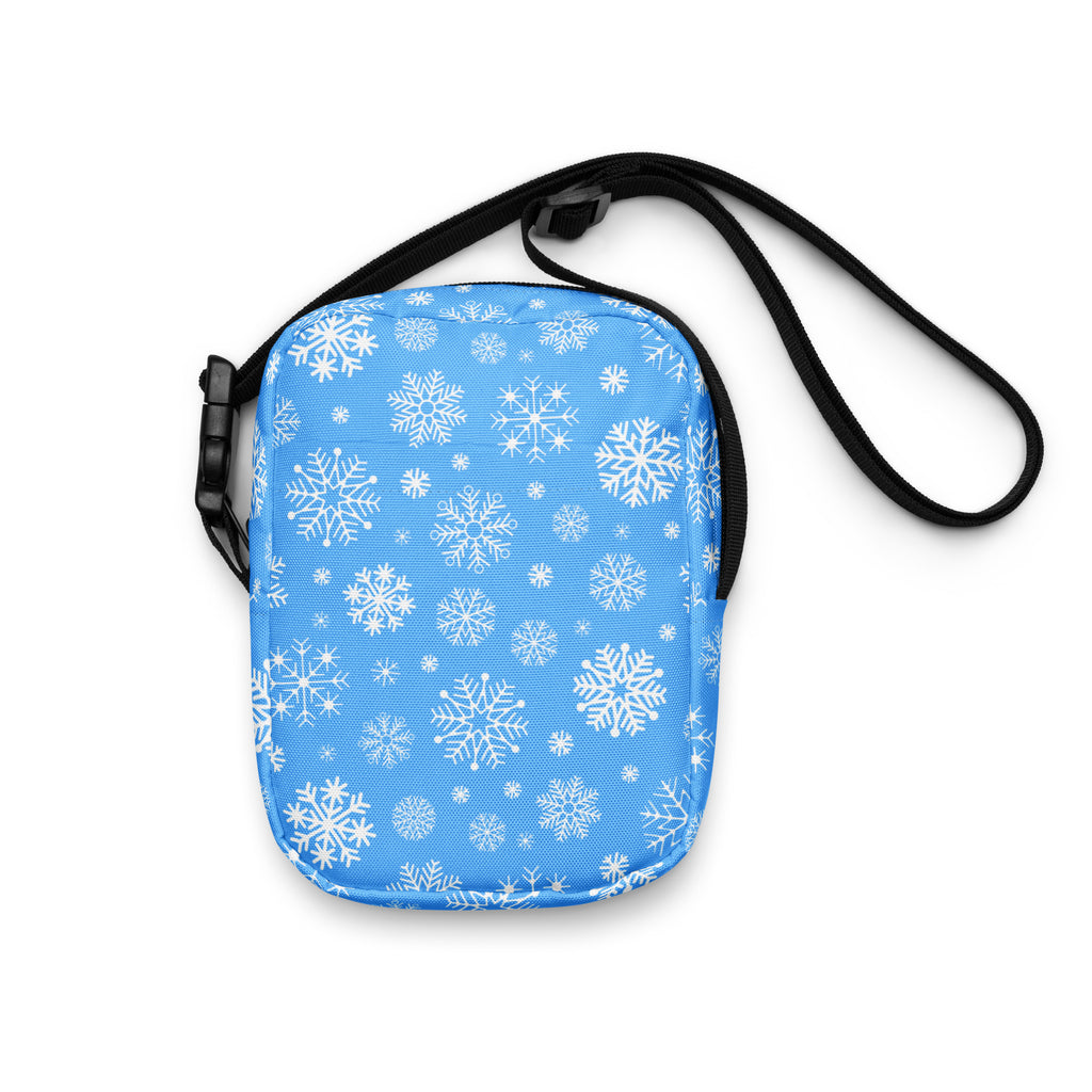 Girls blue snowflake crossbody purse with light blue fabric, white snowflake pattern, and black adjustable strap