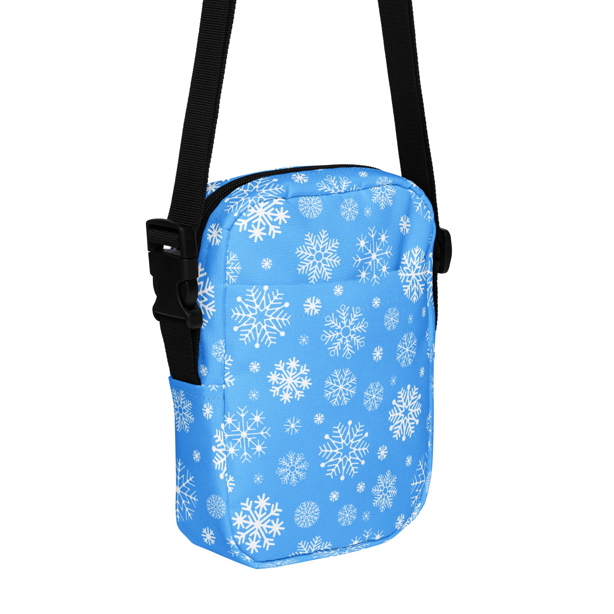 Girls blue crossbody purse with white snowflake pattern and black adjustable strap for easy carrying